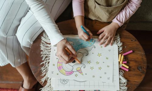 Mother with daughter coloring together